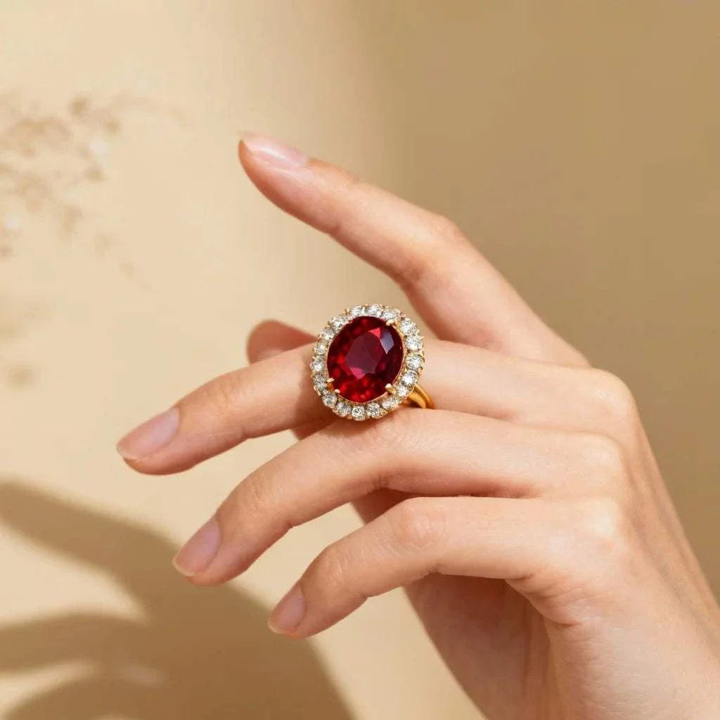 Women’s 14K yellow gold ring with oval ruby and diamond halo on hand size 7