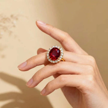 Women’s 14K yellow gold ring with oval ruby and diamond halo on hand size 7