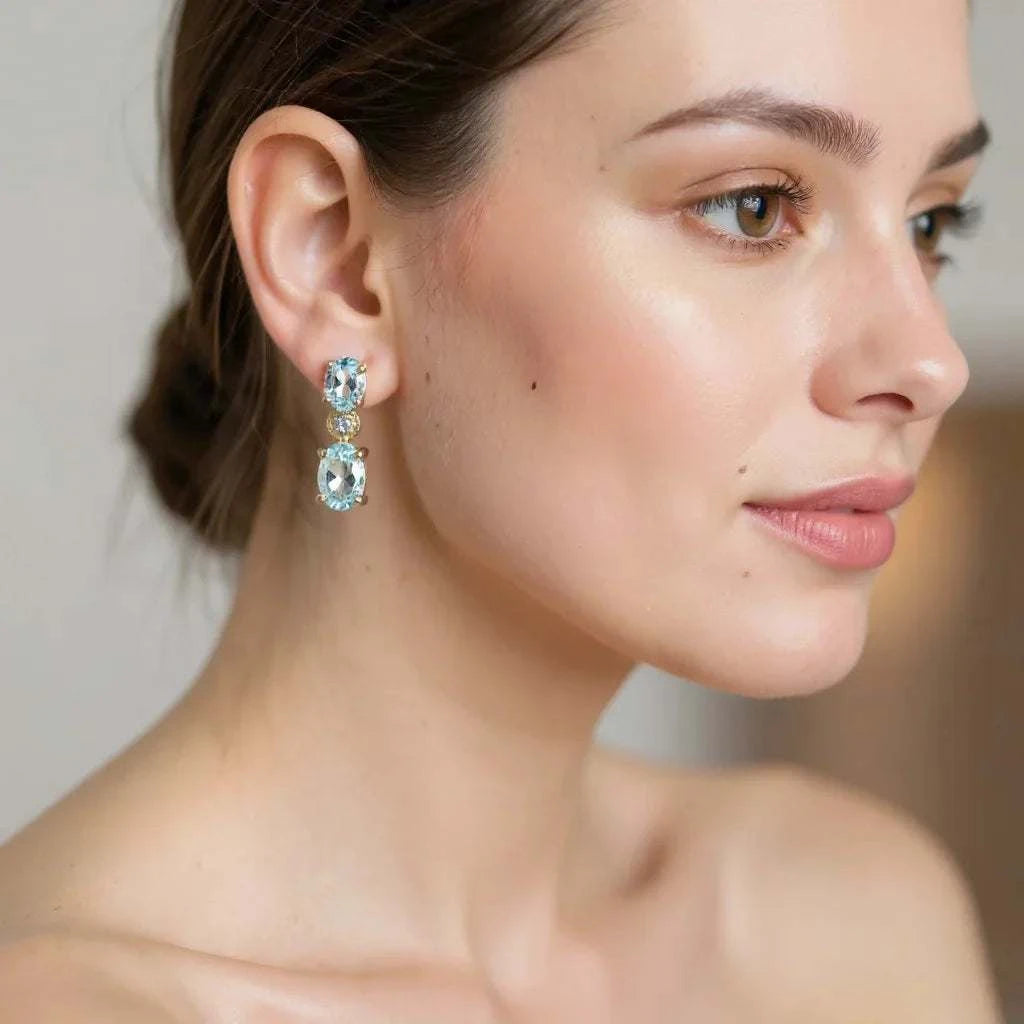 Gorgeous women's earrings featuring 18K yellow gold over sterling silver with blue topaz and diamond accents