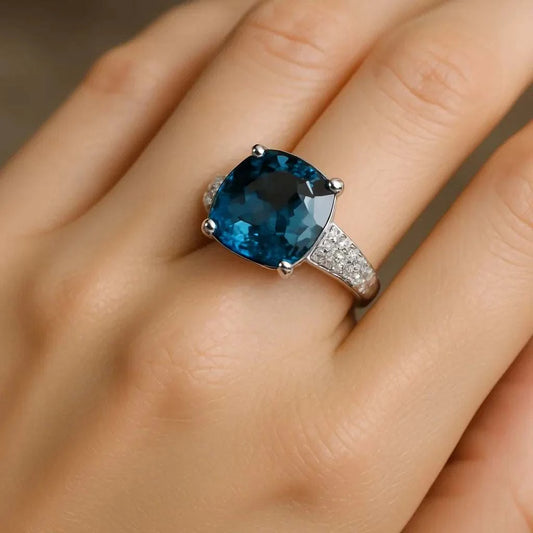 Womens 14K white gold ring with 10 carat London blue topaz and diamond accents on finger