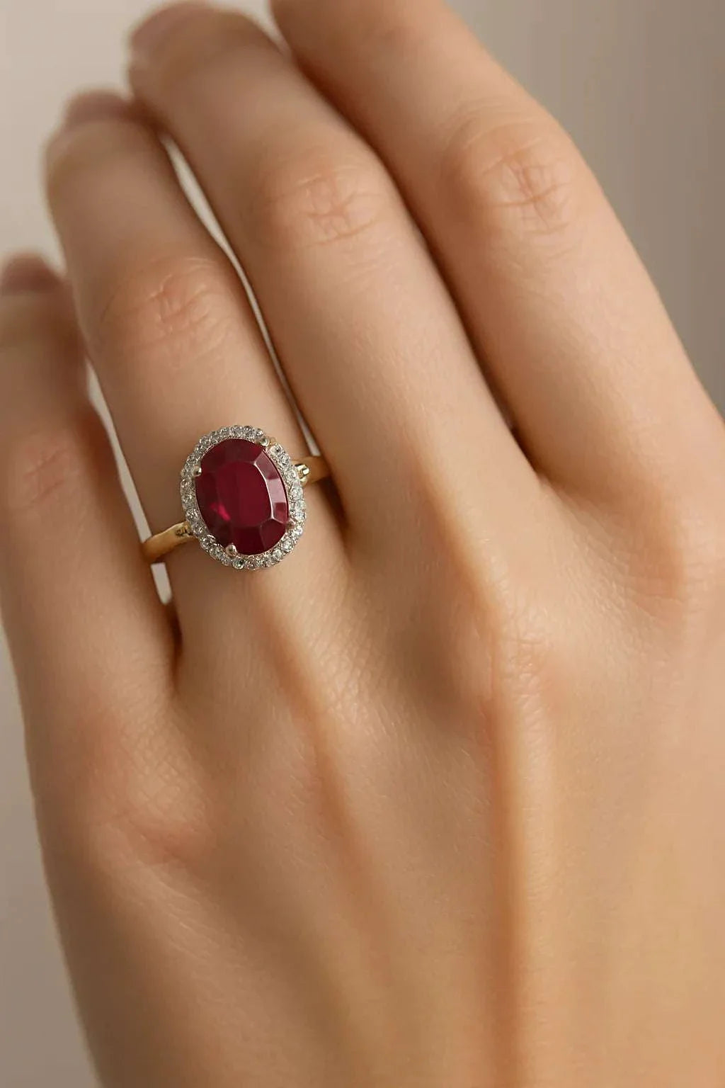 Women’s 14K yellow gold ring with 3.0 CTW ruby and diamond halo, size 7