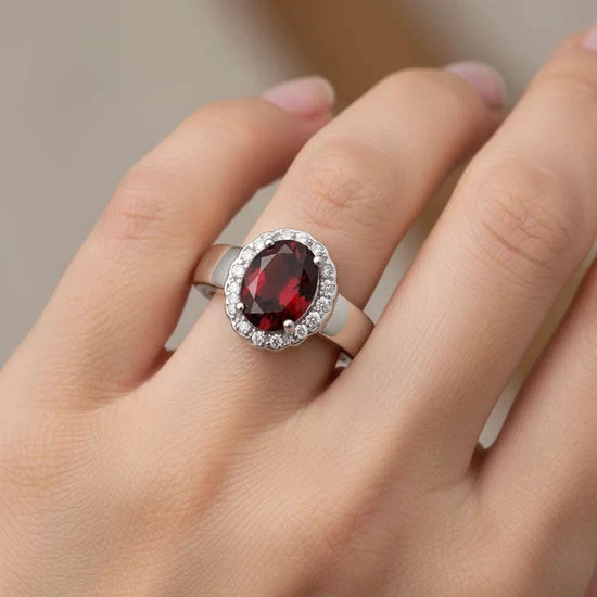 Ladies’ sterling silver garnet and white topaz ring size 7 with oval-cut garnet and round-cut topaz gemstones
