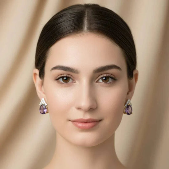 Woman wearing 18K yellow gold plated sterling silver earrings with pear-cut amethyst and round diamond accents