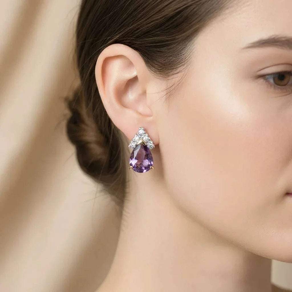 Close-up of woman's ear wearing 18K yellow gold over sterling silver pear-cut amethyst and diamond earrings