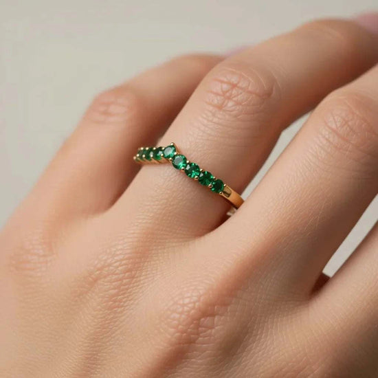 10K yellow gold emerald designer ring with round-cut green emeralds on finger size 7