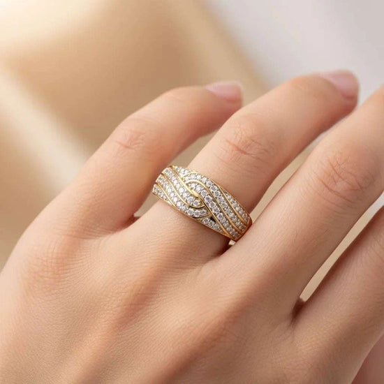 Women’s 14K yellow gold diamond ring on hand, size 7, with round-cut diamonds and sterling silver base