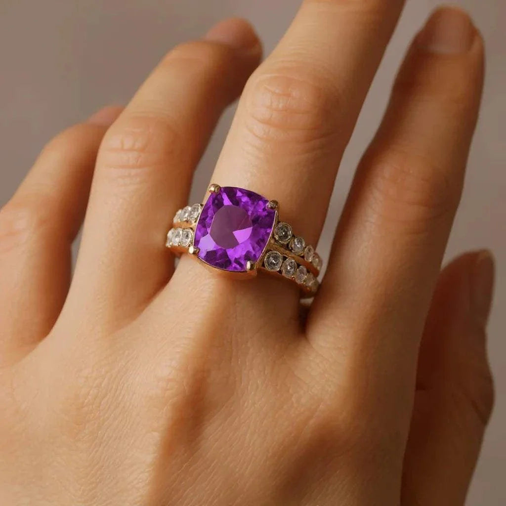 Ladies’ 14K two-tone gold ring featuring cushion-cut amethyst and round diamonds on hand