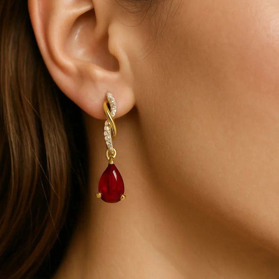 Women’s 14K yellow gold earrings with pear-cut ruby and round diamonds in teardrop design