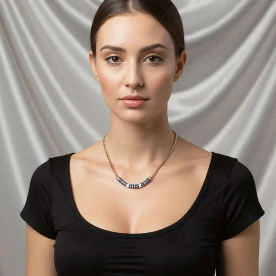 Women’s 18K yellow gold over sterling silver necklace with sapphires and diamonds worn by woman in black top