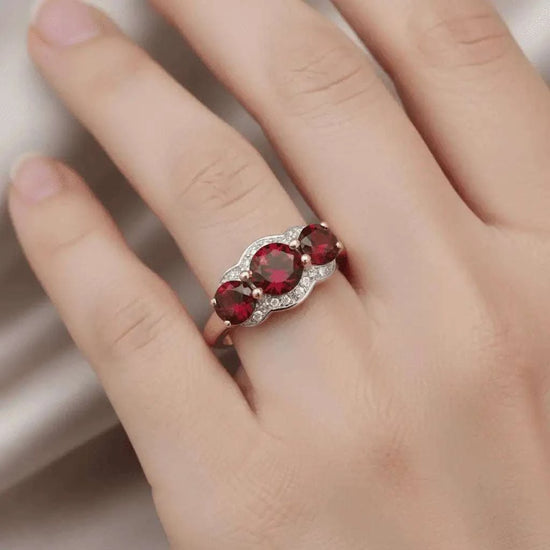 Women’s 14K yellow gold plated sterling silver ring with three round-cut garnets and diamond accents, size 7