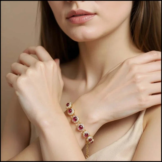 18K yellow gold sterling silver bracelet with oval-cut rubies and round-cut diamonds on woman’s wrist