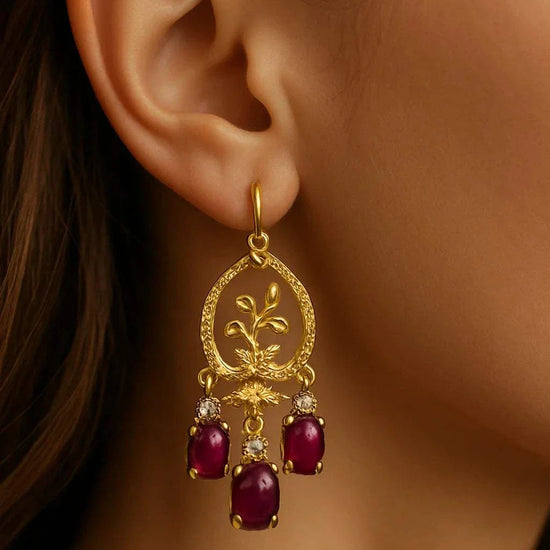 Women’s 18K yellow gold chandelier earrings with vibrant rubies and diamond accents