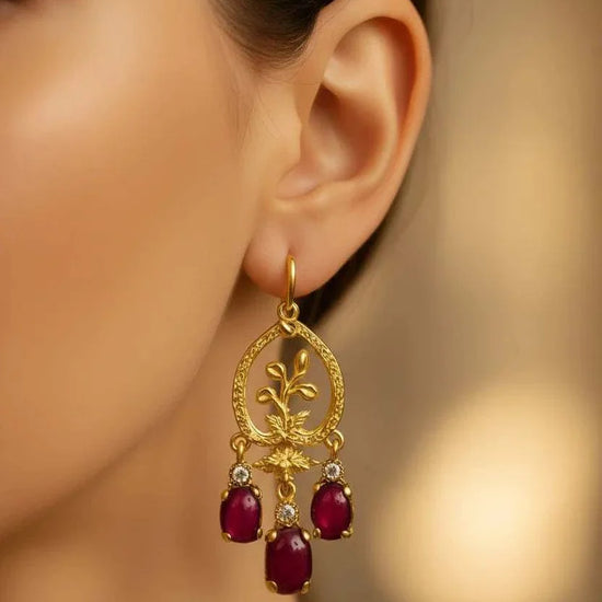 Women’s 18K yellow gold chandelier earrings with vibrant ruby drops and diamond accents