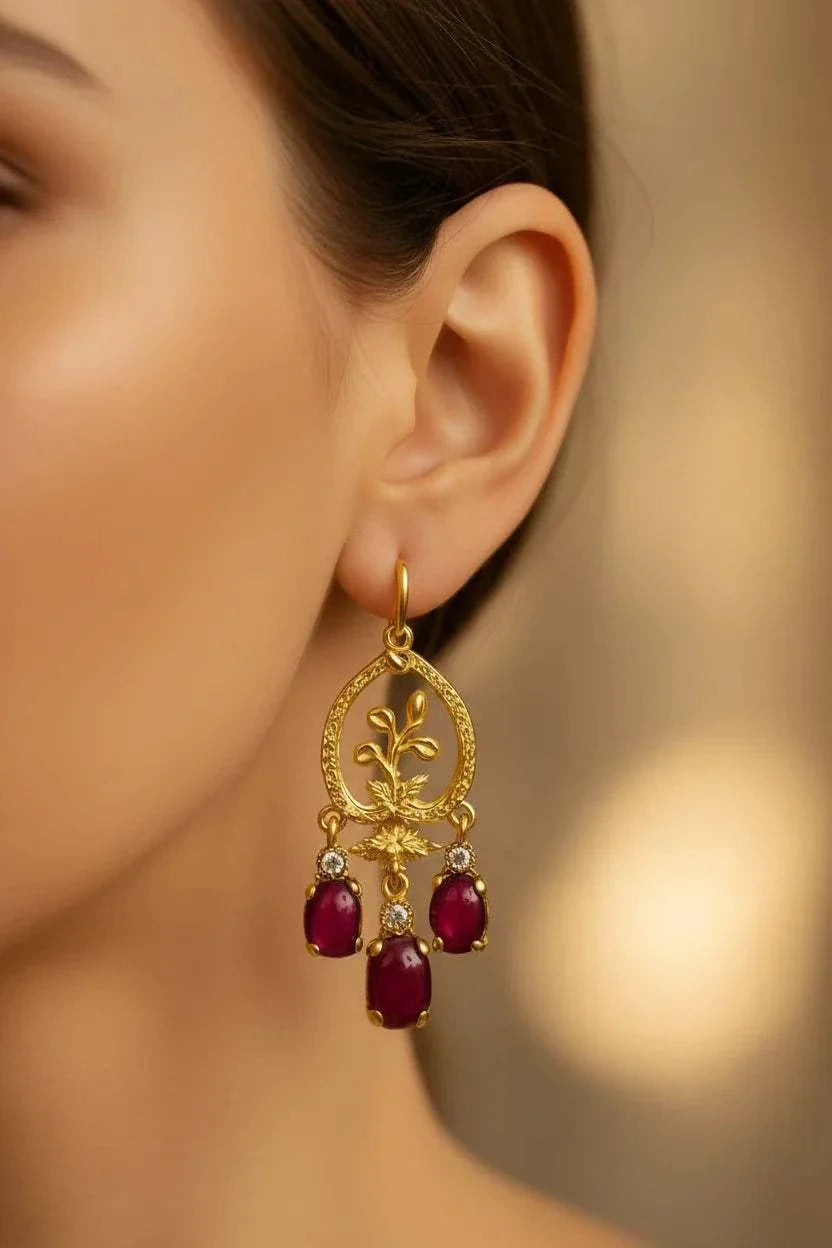 Women’s 18K yellow gold chandelier earrings with vibrant ruby drops and diamond accents