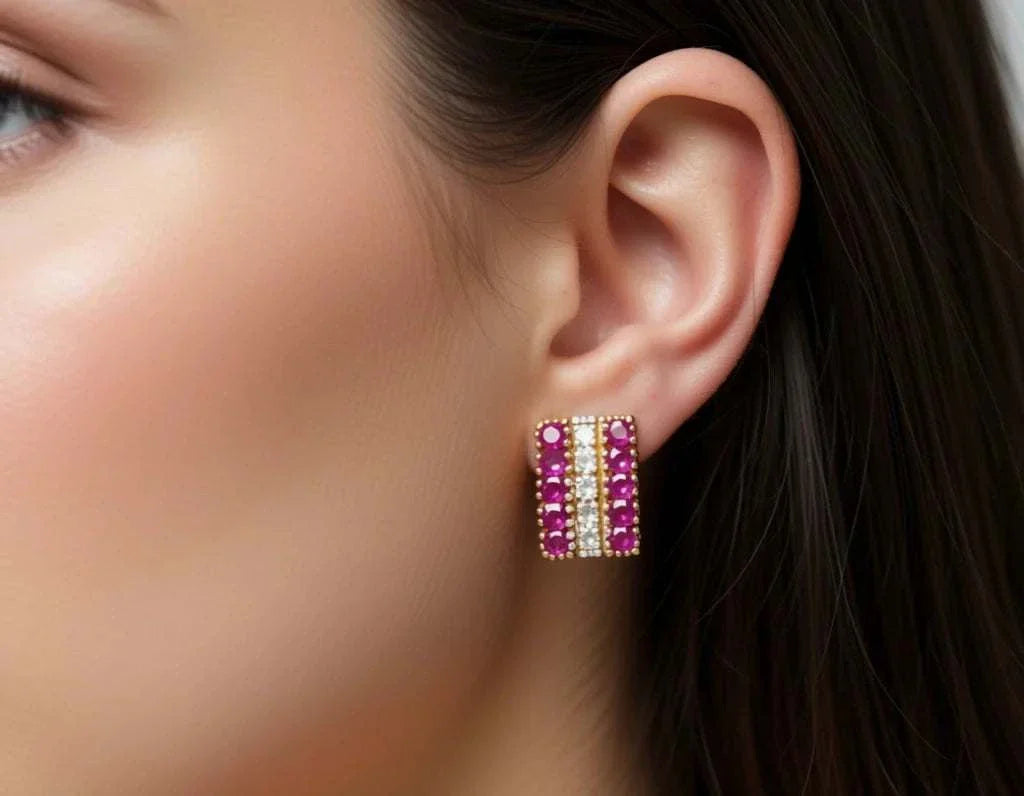 Women’s 18K yellow gold plated earrings with rubies and diamonds close-up on ear