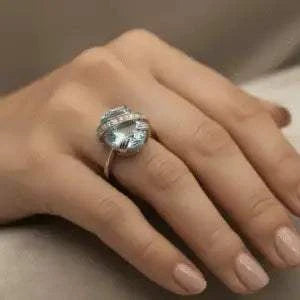 Womens white gold rhodium ring with 5.25 ct oval sky blue topaz and 0.13 ct round white topaz in sterling silver