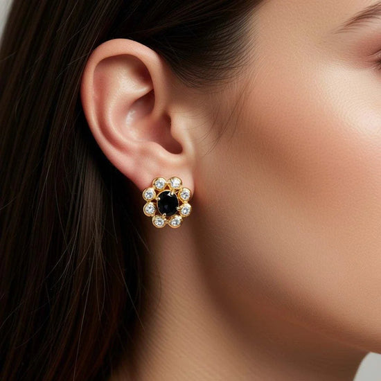 Women’s 18K yellow gold earrings with oval sapphire center and round diamond accents