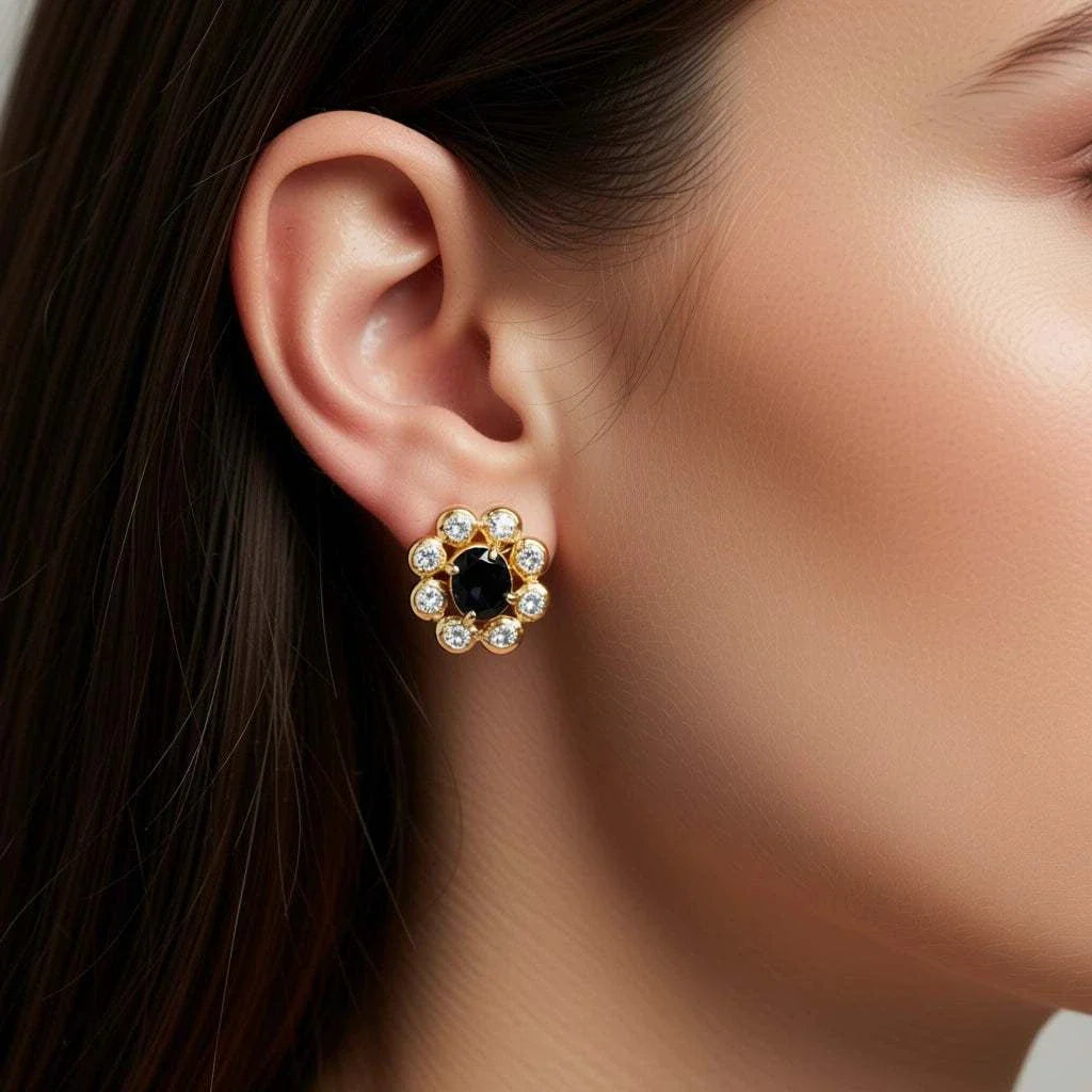 Women’s 18K yellow gold earrings with oval sapphire center and round diamond accents