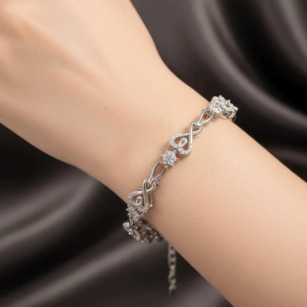 Womens 14K white gold and sterling silver diamond bracelet on wrist with intricate design and round cut diamonds