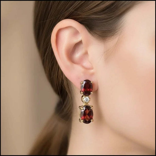 Women’s 18K yellow gold earrings with red garnets and round-cut diamonds