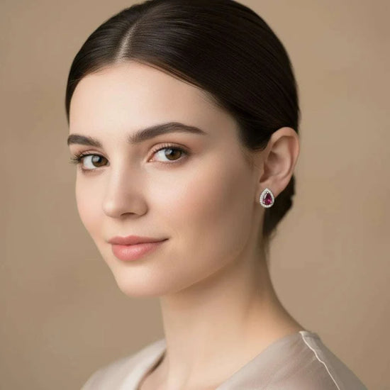 Woman wearing 18K yellow gold over sterling silver garnet and diamond droplet earrings
