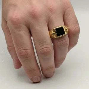 Bold men's ring featuring sterling silver base with 14K yellow gold plating, black onyx center, and black diamond accents.