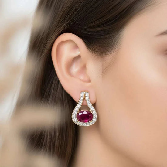 Women's 18K yellow gold over sterling silver teardrop earrings with ruby and diamond accents worn on ear