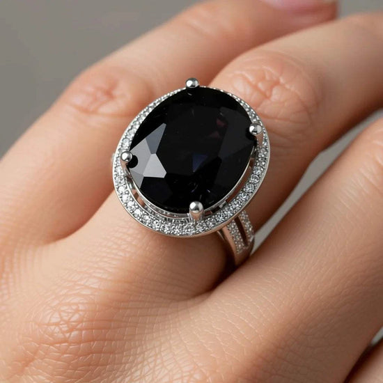 Women's 14K white gold sapphire and diamond ring with large oval black sapphire centerpiece and diamond accents
