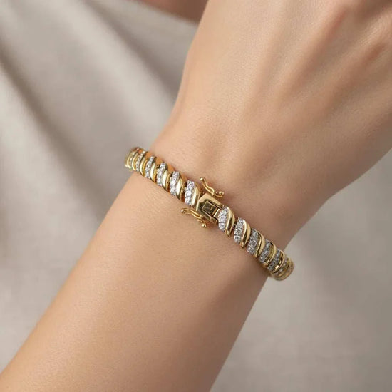 Women’s 18K yellow gold over sterling silver diamond bracelet on wrist with round-cut diamonds