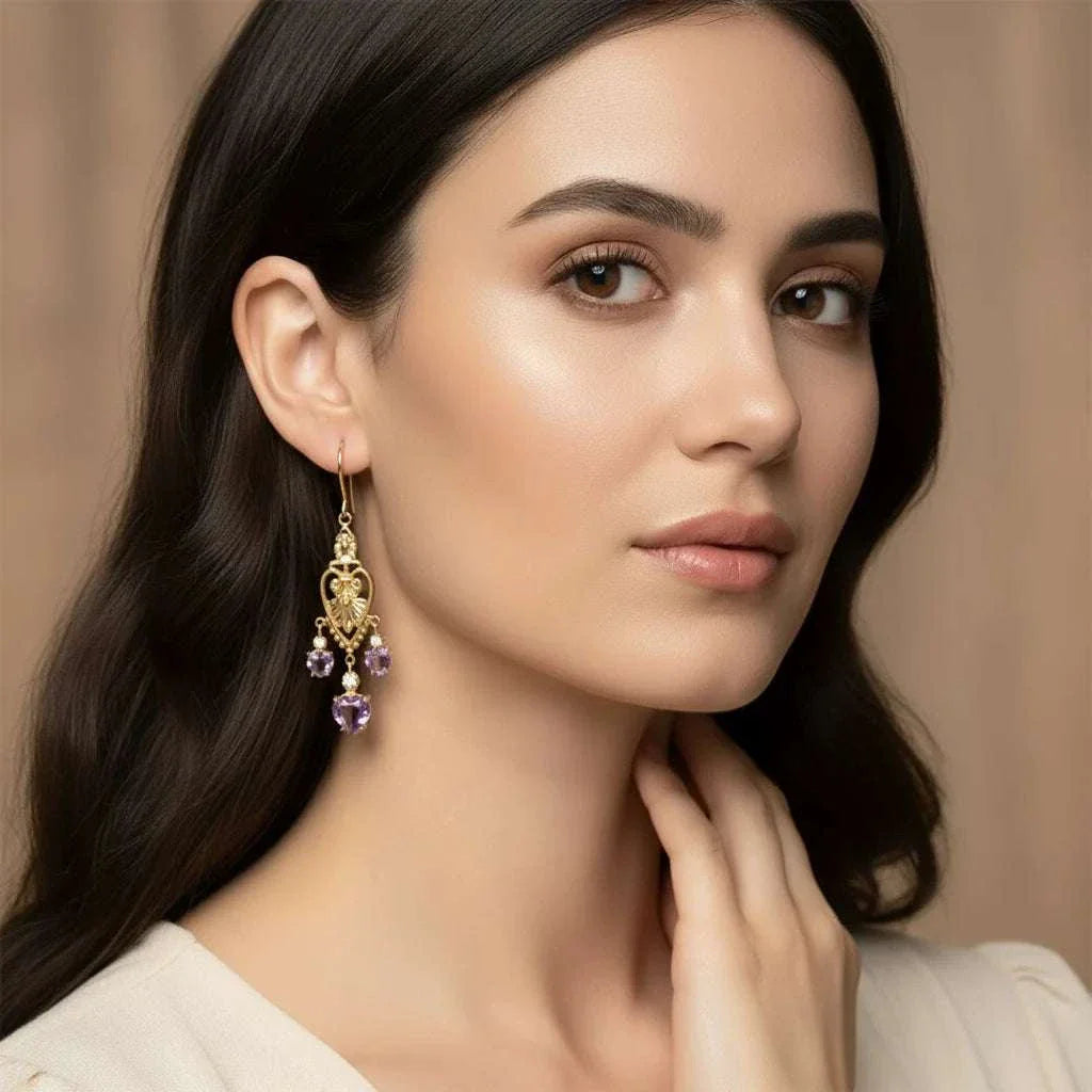 Victorian heart-inspired earrings with amethysts and diamonds in 18K gold-plated sterling silver worn by woman