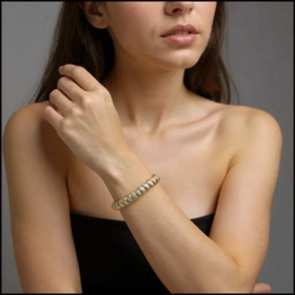 Women’s 18K yellow gold over sterling silver diamond bracelet on wrist showcasing elegant round-cut diamonds and sleek design