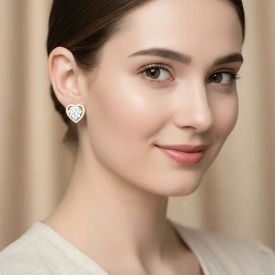 Woman wearing women’s white gold rhodium plated sterling silver heart-shaped diamond earrings