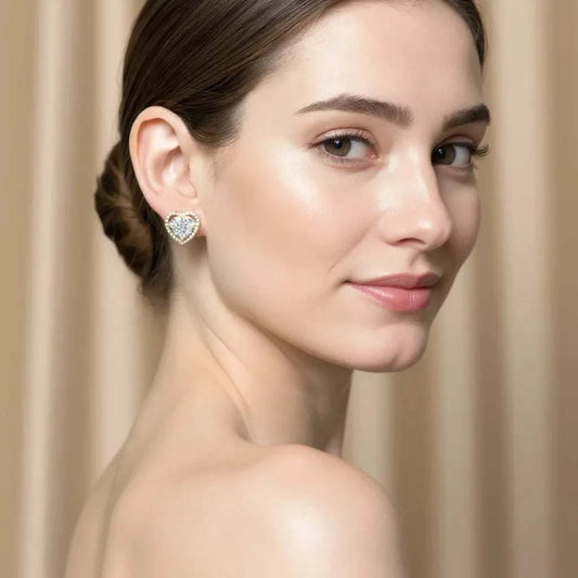 Women’s white gold rhodium plated sterling silver heart-shaped diamond earrings worn by model